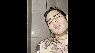 Tattooed young guy jerking off in the shower