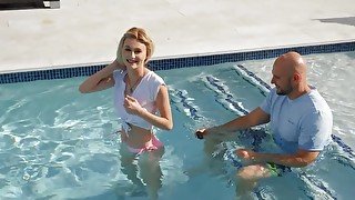 Tiny blonde facialized after sex with ball bruiser by the pool