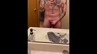 Stoking cock while in front of mirror.