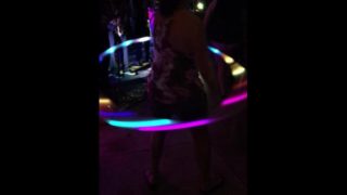 My female friend dancing in flip flops with her Holahoop!