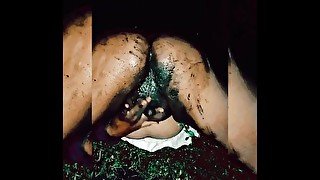 Slutty transsexual masturbates filling her pussy with mud