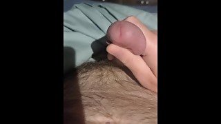 Playing with pre-cum from a soft cock