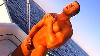 Muscled stud caresses his hot body and pleases his big dick on a boat