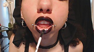 Goth Girl Applying Black Lip Gloss and Teasing with Kisses