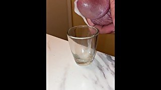 Collecting my cum in a shot glass, breathing heavy and moaning squeezing it out of my dick