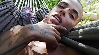 On the hammock. I lick my hairy armpits and play whit my asshole.