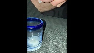 Trying to milk my cum into a shot glass while filming, failed a little bit on aiming