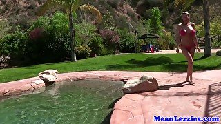 Busty lesbians licking pussy outdoors by pool