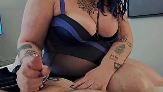 BBW MiLF with big tits and tattoos gives pierced cock a hand job.