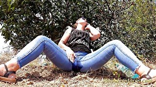 Pissing trough her jeans while talking on the phone