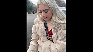 A nice blondie in colorfull dress is smoking and spitting