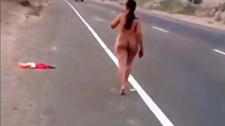 Latina girl walking nude by the road