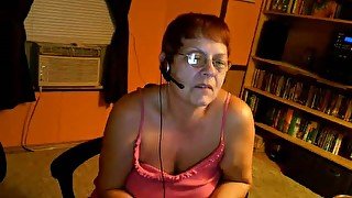 Redhead mature speaks with a young lover over the webcam