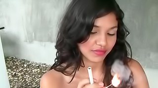 Asian babe is smoking a cigarette so hot