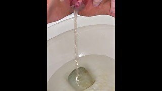 Shaved dirty pussy has longest continuous piss in toilet