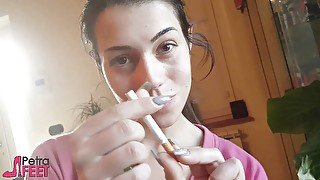 Tempting Italian girl smokes a cigar in a close up video