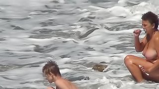 Voyeur films nude ladies on the beach