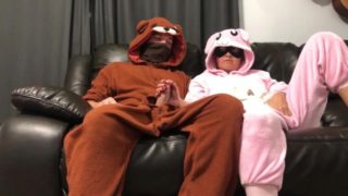 Bunny pajama girl gives handjob on couch watching tv