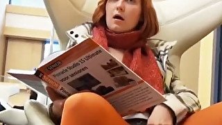 Nasty and ugly redhead bitch is fingering her pussy in a library