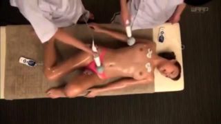 Stacked Oriental beauty is made to cum on the massage table