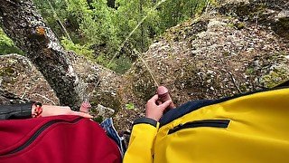 Two tight streams of urine cross in the mountains. Pissing outdoor UHD 4K video