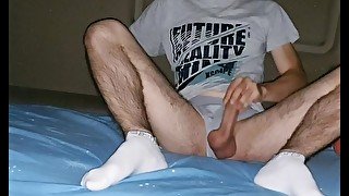 Teenager with grey underwear and sports socks masturbates and shots his sperm