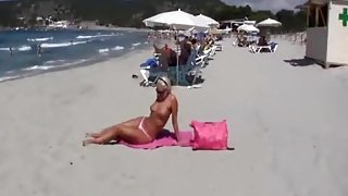 Tanning mother I'd like to fuck on beach is exhibitionist