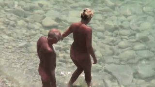 Handjob given by mature wife on public beach