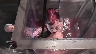 Redhead slut gets suspended and immersed in the water