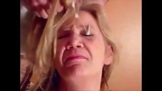 Blonde granny is taking a cumshot on her eyes