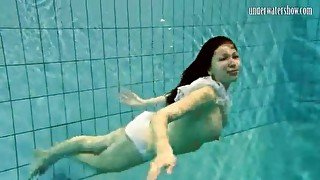 Girl in white panties swims in pool