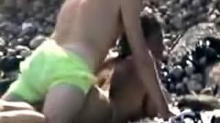 Woman gets her snatch pounded from behind on a beach