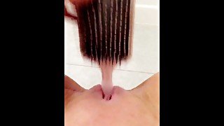 Naughty teen fucks her tiny pussy with hairbrush in school bathroom