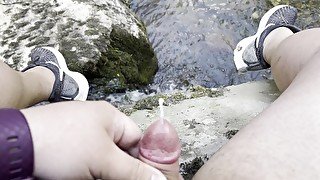 Sitting on a stone next to a stream in a national park in Turkey