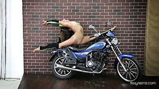 Super flexible babe Ninka Motik takes some horny poses near the bike