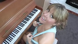 Sexy blonde Talia is playing on piano