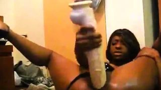 Chocolate beauty pulls her panties to the side and fucks a huge dildo