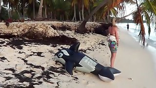 Riding an inflatable whale at the beach - nonpop