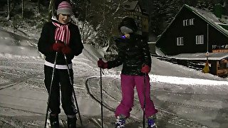 Playful teens Linda and Lilly are passionately kissing while skiing at night