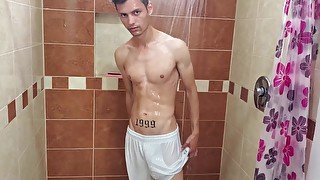 Hot guy jerks off his uncut cock in the shower and cums sweetly