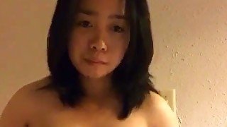 Asian short haired brunette with big titties rubs her hungry pussy