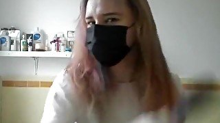 Girl painting her hair in surgical mask and gloves