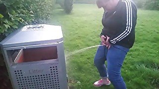 Piss into bin in the park