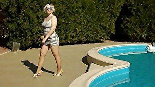 Pretty woman by the pool in pantyhose and heels