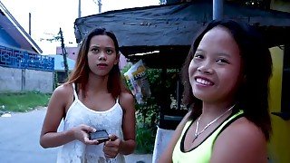 Two petite Asian village girls share a white man's dick