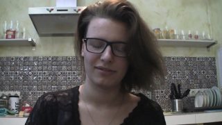 Solo girl with glasses chatting in the kitchen