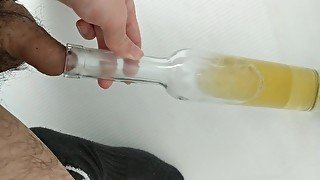 Filling up a wine bottle with piss