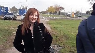 Busty redhead blowjob in a park