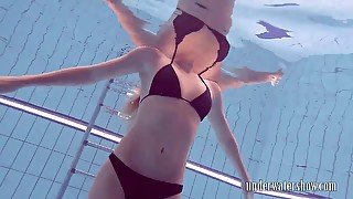 Charming slender girl flashes her impressive pubic hair underwater