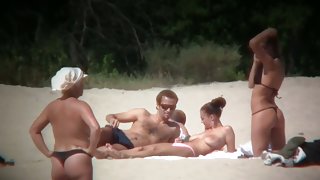 Huge boobed sexy ladies lie on the beach and relaxing